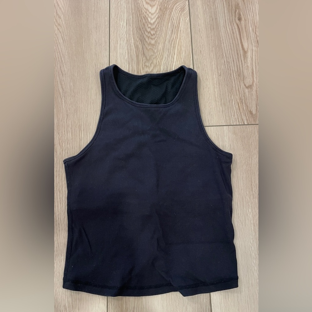Vuori black ribbed tank top. Slightly cropped. Built in bra, no pads.